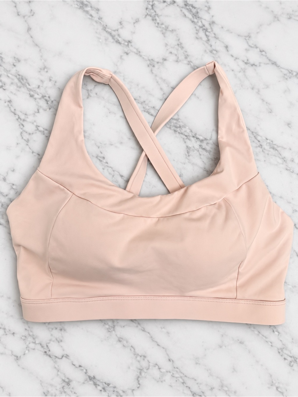 Women's Light Pink Strappy Sports Bra with sewn in padding.